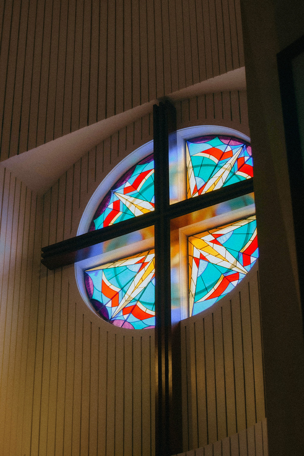 Concept image: an uninstalled framed window sample with diamond-pattern beveled glass, standing on a neutral studio floor.