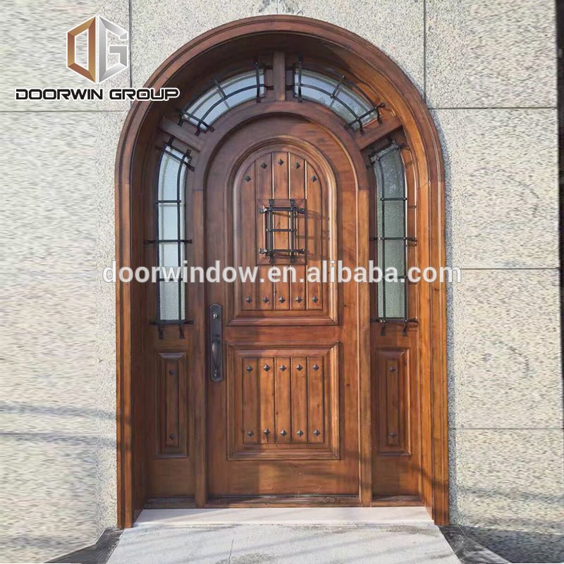 Home entrance door outside front doors with decorative wrought iron clavos by Doorwin - Doorwin Group Windows & Doors